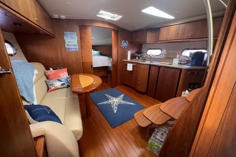 Slide: The Image of Interior of 2012 Tiara Yachts 3900 Sovran, featuring cozy seating and elegant wood finishes. - 29