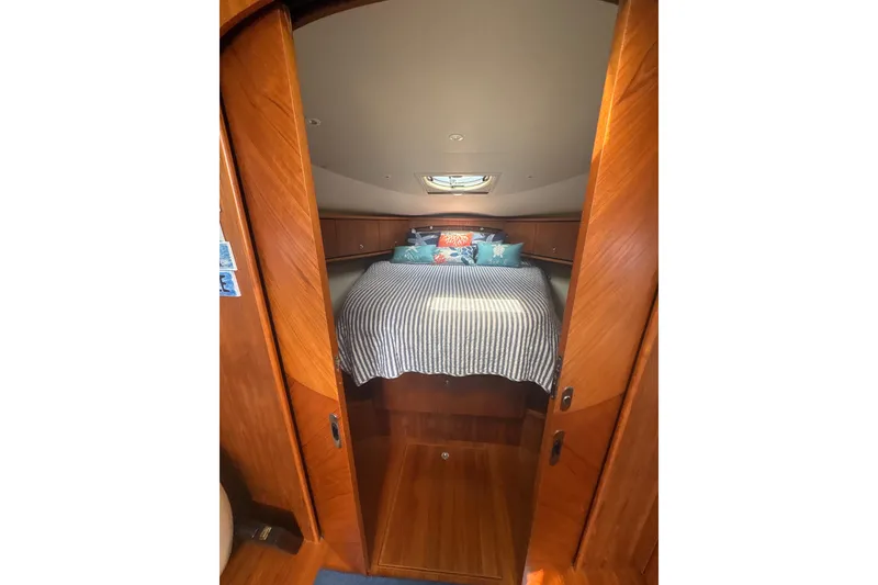Slide: The Image of 2012 Tiara Yachts 3900 Sovran cabin with cozy bed and wooden interior. - 35