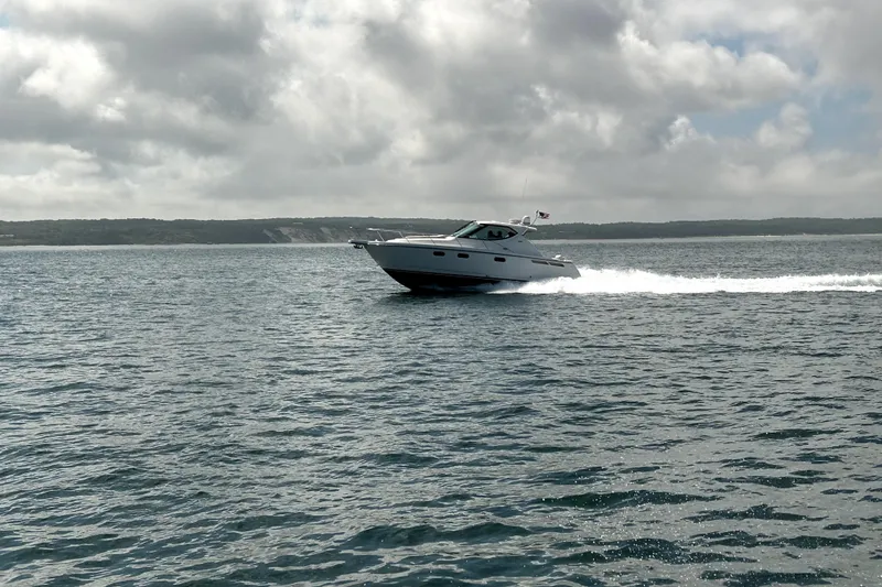 Slide: The Image of 2012 Tiara Yachts 3900 Sovran cruising on open water under cloudy skies. - 6