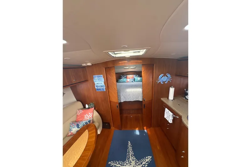Slide: The Image of Interior of 2012 Tiara Yachts 3900 Sovran, featuring cozy cabin with nautical decor. - 32