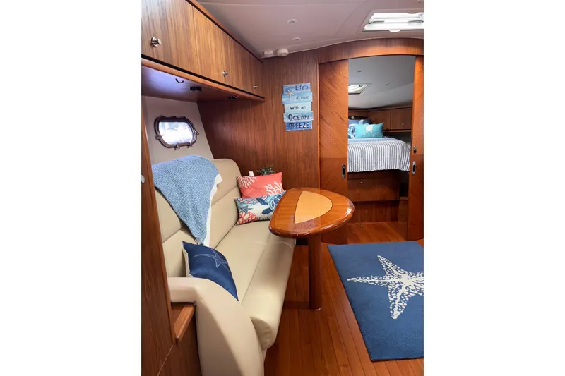 Slide: The Image of Interior of 2012 Tiara Yachts 3900 Sovran with cozy seating and nautical decor. - 31