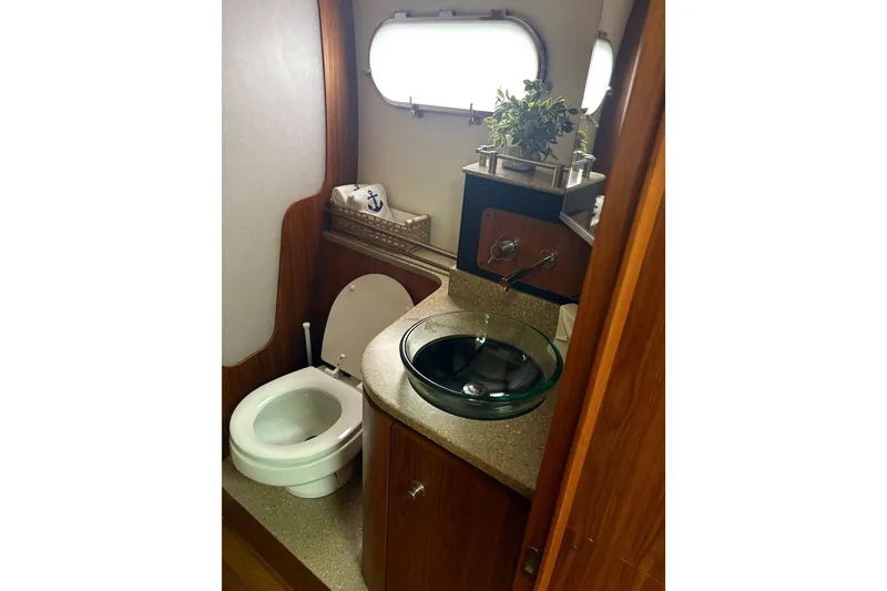 Slide: The Image of Bathroom interior of 2012 Tiara Yachts 3900 Sovran with modern fixtures and porthole window. - 40