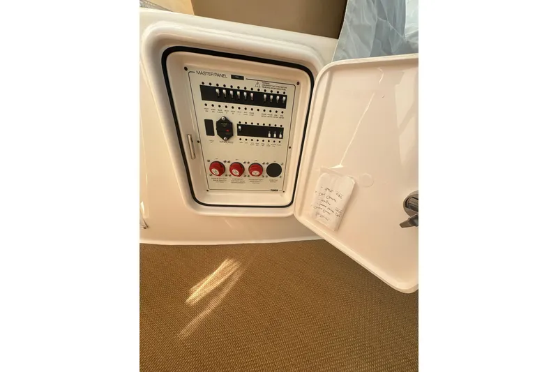 Slide: The Image of Electrical panel of a 2012 Tiara Yachts 3900 Sovran, showcasing control switches and labels. - 20