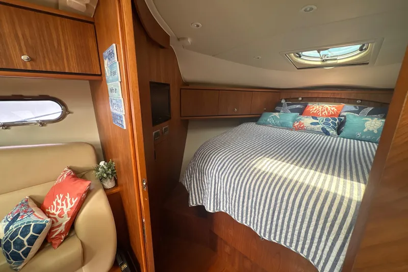 Slide: The Image of Interior of 2012 Tiara Yachts 3900 Sovran with cozy bed and nautical decor. - 34