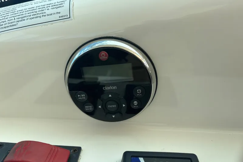 Slide: The Image of Clarion audio control panel on 2012 Tiara Yachts 3900 Sovran dashboard. - 17
