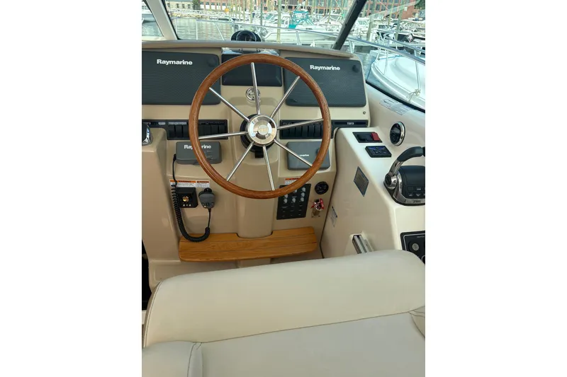 Slide: The Image of Helm of 2012 Tiara Yachts 3900 Sovran with Raymarine electronics and wooden steering wheel. - 13