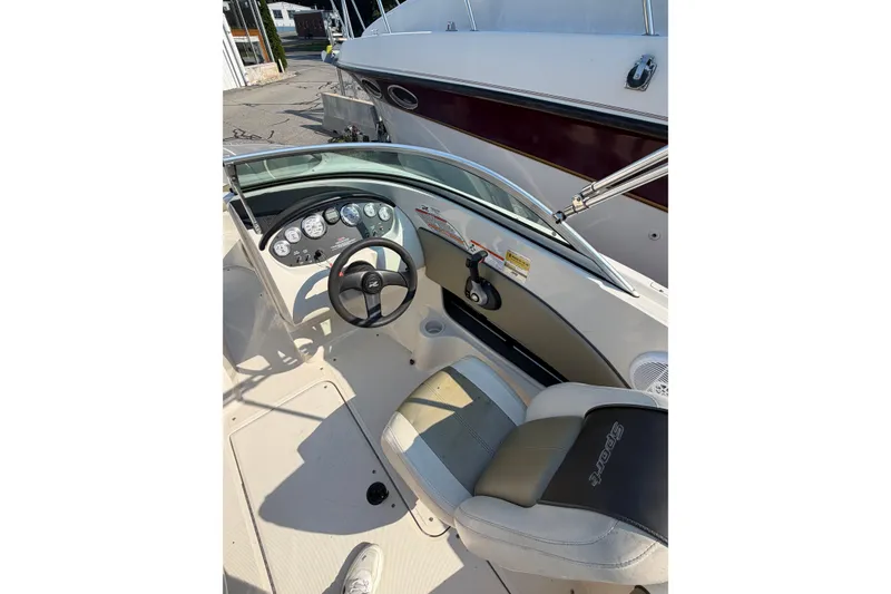 Slide: The Image of 2006 Sea Ray 195 Sport boat interior with steering wheel and dashboard controls. - 7