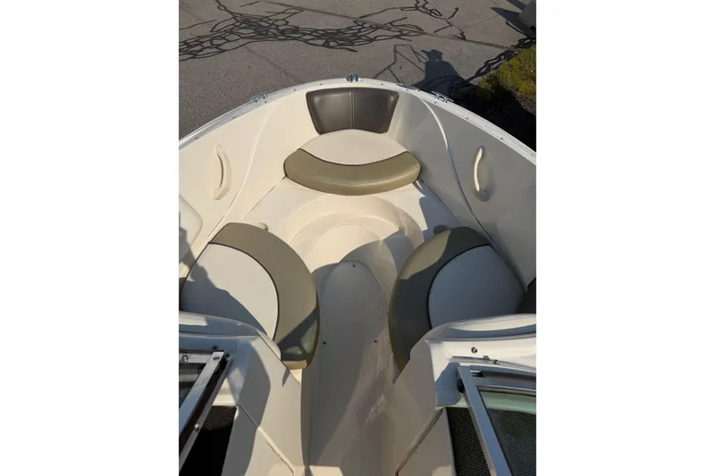 Slide: The Image of 2006 Sea Ray 195 Sport boat interior with cushioned seating in sunlight. - 8