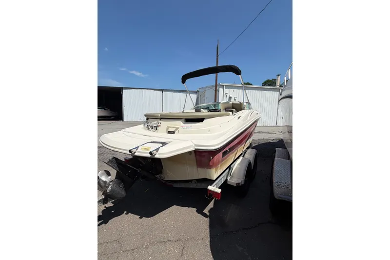 Slide: The Image of 2006 Sea Ray 195 Sport boat on trailer, parked outdoors under clear blue sky. - 5