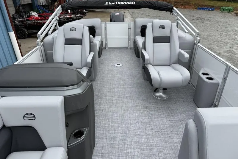 Slide: The Image of 2026 Sun Tracker Party Barge 22 DLX interior with gray seating and modern design. - 12