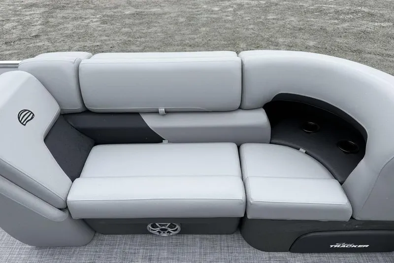 Slide: The Image of 2026 Sun Tracker Party Barge 22 DLX seating area with gray upholstery and cup holders. - 5