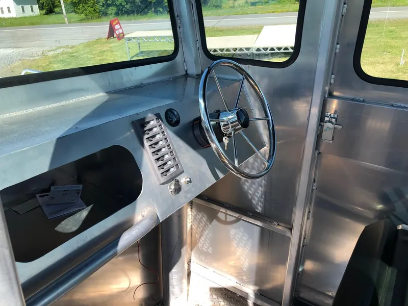 Slide: The Image of Interior view of a workboat with steering wheel and control console. - 12