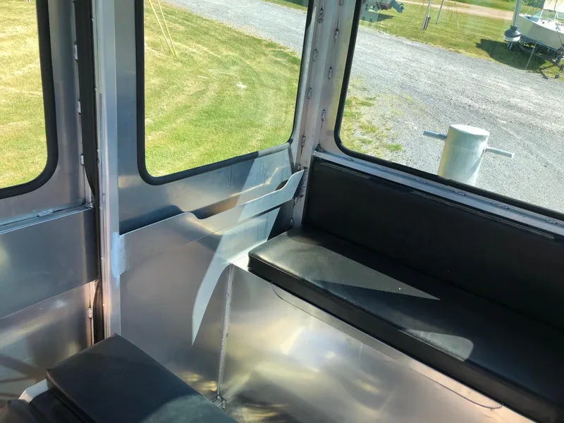 Slide: The Image of Interior view of a modern workboat with black seating and metal walls. - 11