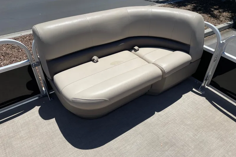 Slide: The Image of 2025 Sun Tracker Party Barge 16 DLX pontoon boat seating, beige upholstery, outdoor setting. - 5