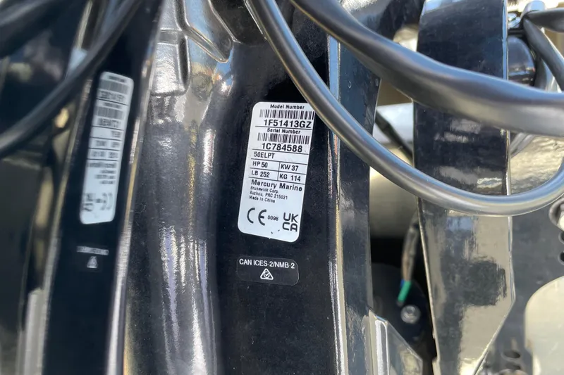Slide: The Image of Label on Sun Tracker Party Barge 16 DLX 2025, featuring Mercury Marine engine details. - 58