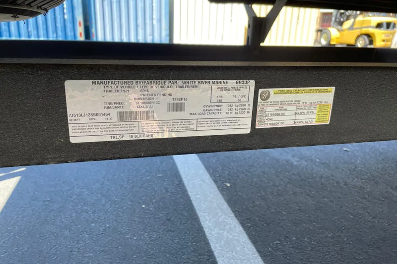 Slide: The Image of Label on Sun Tracker Party Barge 16 DLX trailer, 2025 model, showing specifications and tire information. - 59
