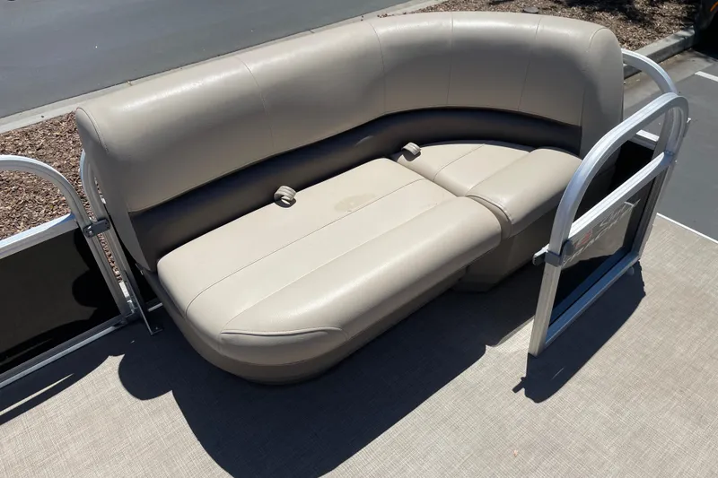 Slide: The Image of 2025 Sun Tracker Party Barge 16 DLX pontoon boat seating, beige upholstery, sunny day. - 4