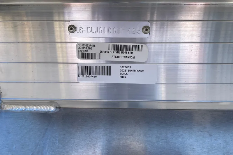 Slide: The Image of 2025 Sun Tracker Party Barge 16 DLX identification labels on metallic surface. - 57