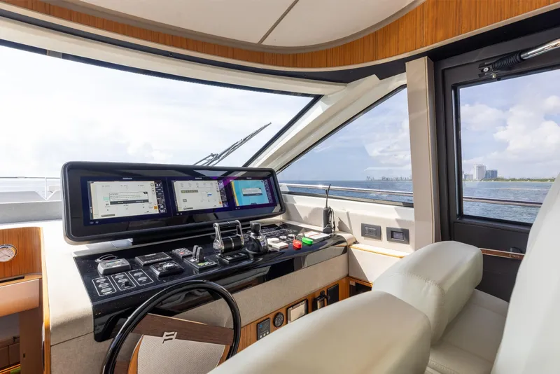 Slide: The Image of Modern helm of 2025 Ferretti Yachts 670 with advanced navigation displays and controls. - 13