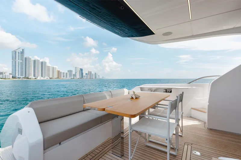 Slide: The Image of Luxurious 2025 Ferretti Yachts 670 deck with ocean view and modern seating area. - 5