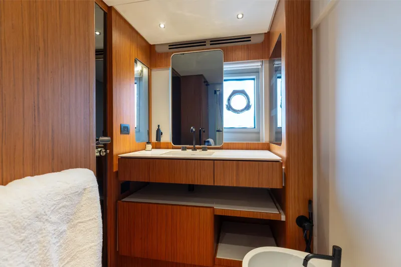 Slide: The Image of Luxurious bathroom interior of 2025 Ferretti Yachts 670, featuring modern wood finishes and elegant fixtures. - 18