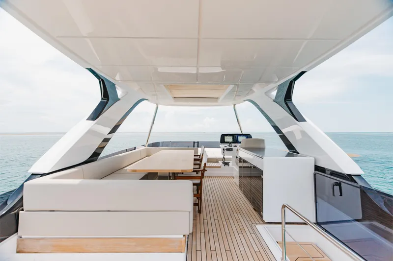 Slide: The Image of Luxurious 2025 Ferretti Yachts 670 flybridge with elegant seating and ocean view. - 32