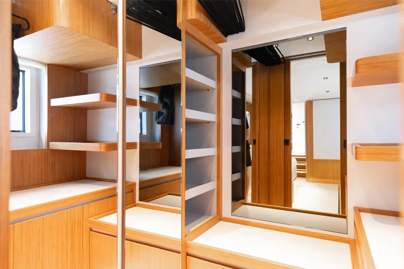 Slide: The Image of Luxurious interior of 2025 Ferretti Yachts 670 with modern wood finishes and mirrors. - 17