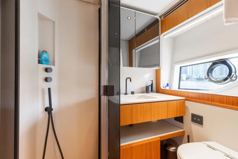 Slide: The Image of Luxurious bathroom interior of 2025 Ferretti Yachts 670, featuring modern fixtures and a scenic window view. - 21