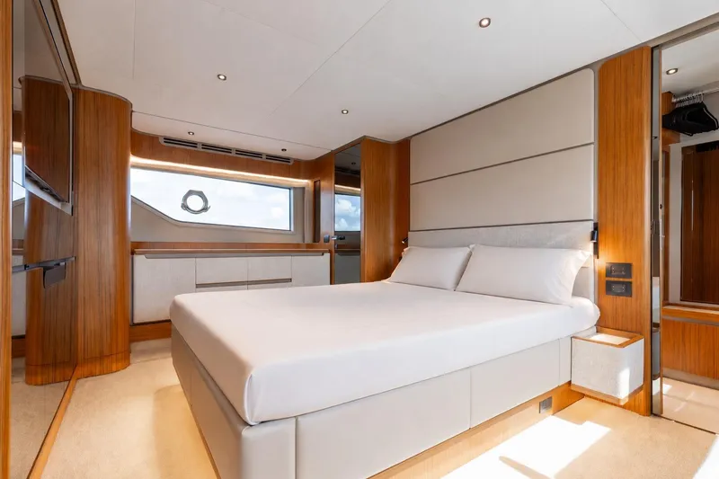 Slide: The Image of Luxurious bedroom interior of 2025 Ferretti Yachts 670, featuring modern design and elegant wood finishes. - 14