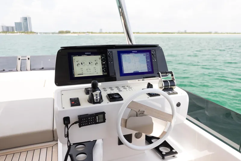 Slide: The Image of Helm of 2025 Ferretti Yachts 670 with advanced navigation displays and controls. - 33