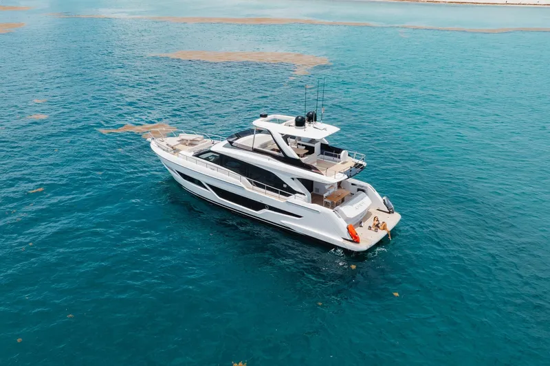 Slide: The Image of Luxurious 2025 Ferretti Yachts 670 cruising on clear blue ocean waters. - 38