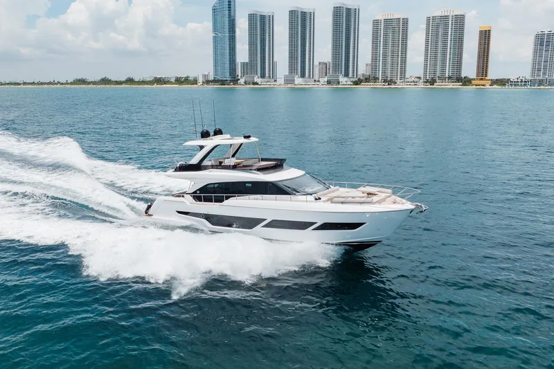 Slide: The Image of 2025 Ferretti Yachts 670 cruising near city skyline on a sunny day. - 35