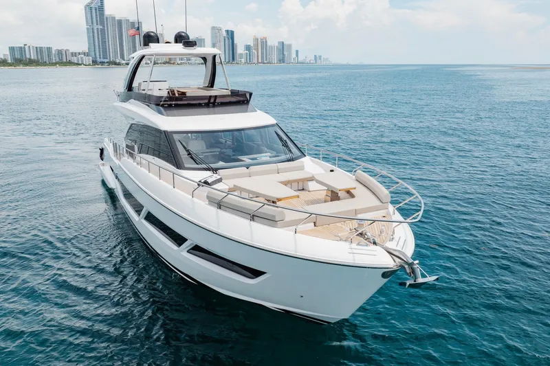 Slide: The Image of 2025 Ferretti Yachts 670 cruising near a city skyline on a sunny day. - 27