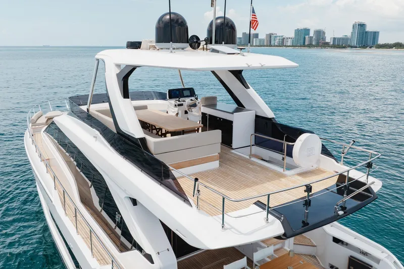 Slide: The Image of Luxury 2025 Ferretti Yachts 670 on serene ocean, showcasing sleek design and spacious deck. - 34
