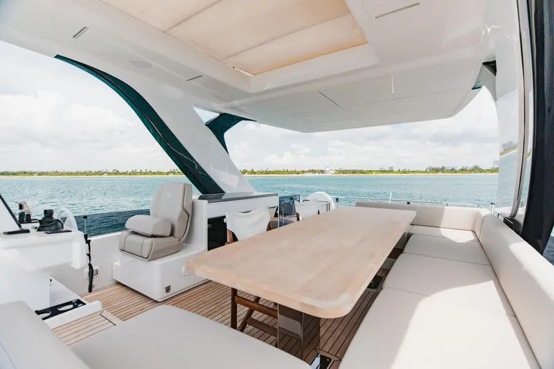 Slide: The Image of Luxurious 2025 Ferretti Yachts 670 interior with elegant seating and ocean view. - 31