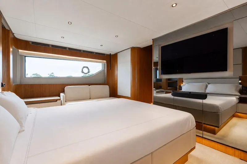 Slide: The Image of Luxurious bedroom interior of 2025 Ferretti Yachts 670 with modern design and large window. - 15