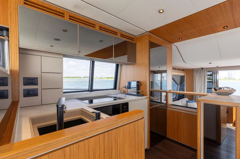 Slide: The Image of Luxurious interior of 2025 Ferretti Yachts 670 with modern kitchen and scenic ocean view. - 11