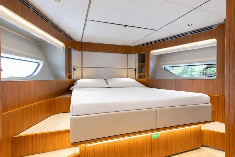 Slide: The Image of Luxurious bedroom interior of 2025 Ferretti Yachts 670 with modern design and wood accents. - 20