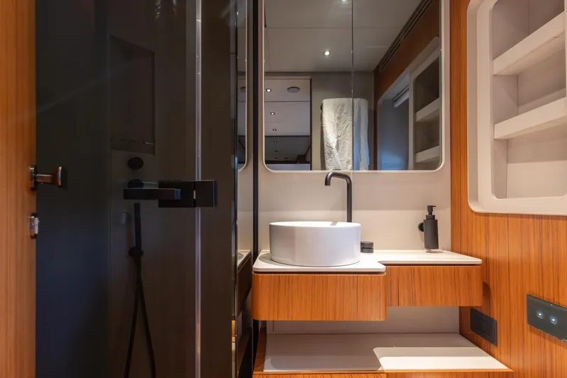 Slide: The Image of Luxurious bathroom interior of 2025 Ferretti Yachts 670 with modern fixtures and wood accents. - 23