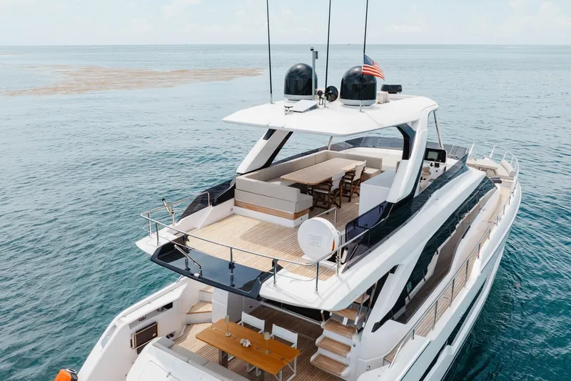 Slide: The Image of Luxurious 2025 Ferretti Yachts 670 cruising on open sea, featuring elegant deck design. - 30