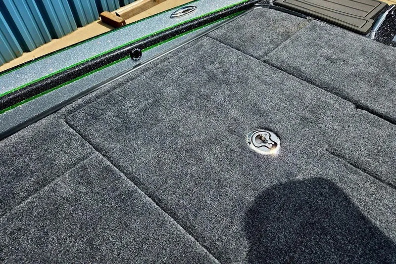 Slide: The Image of 2027 Phoenix 721 ZXL boat deck with gray carpet and metallic latch. - 77