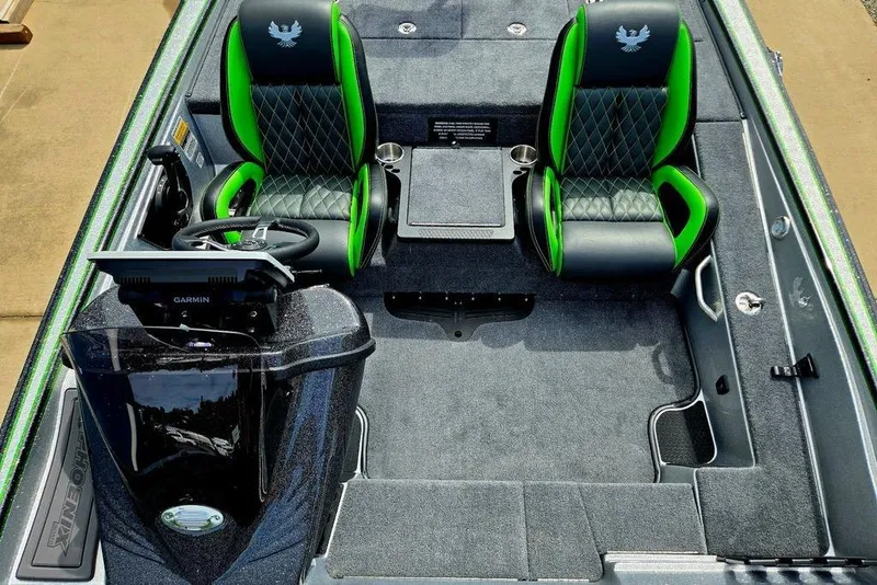 Slide: The Image of 2027 Phoenix 721 ZXL boat interior with green-accented seats and Garmin navigation system. - 35