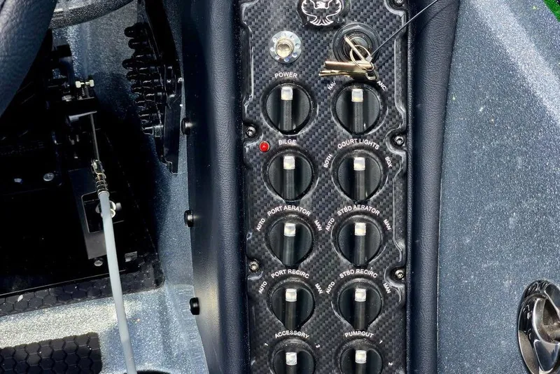 Slide: The Image of Control panel of a 2027 Phoenix 721 ZXL boat with switches and key ignition. - 42