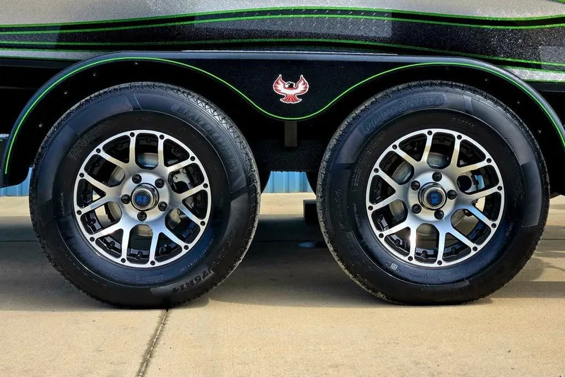 Slide: The Image of 2027 Phoenix 721 ZXL trailer wheels with stylish rims and green accents. - 13