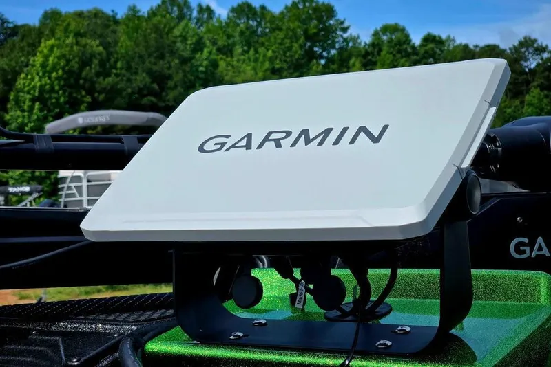 Slide: The Image of Garmin device on 2027 Phoenix 721 ZXL boat, surrounded by lush greenery. - 19