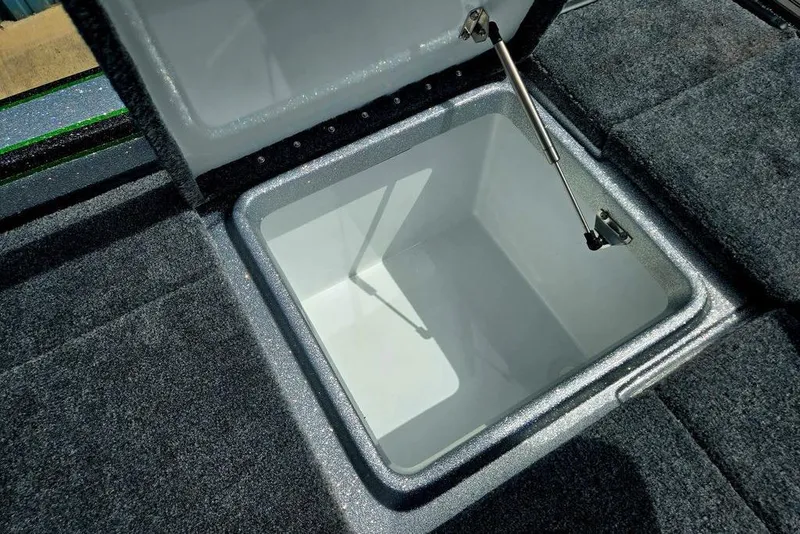 Slide: The Image of Open storage compartment in 2027 Phoenix 721 ZXL boat, featuring carpeted interior and hydraulic lift. - 58