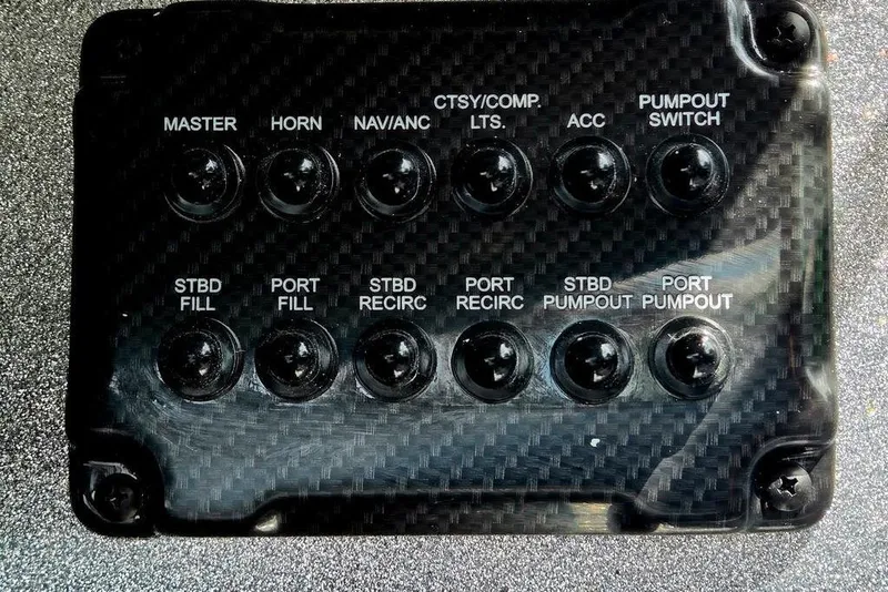 Slide: The Image of Control panel of a 2027 Phoenix 721 ZXL boat with labeled switches. - 36