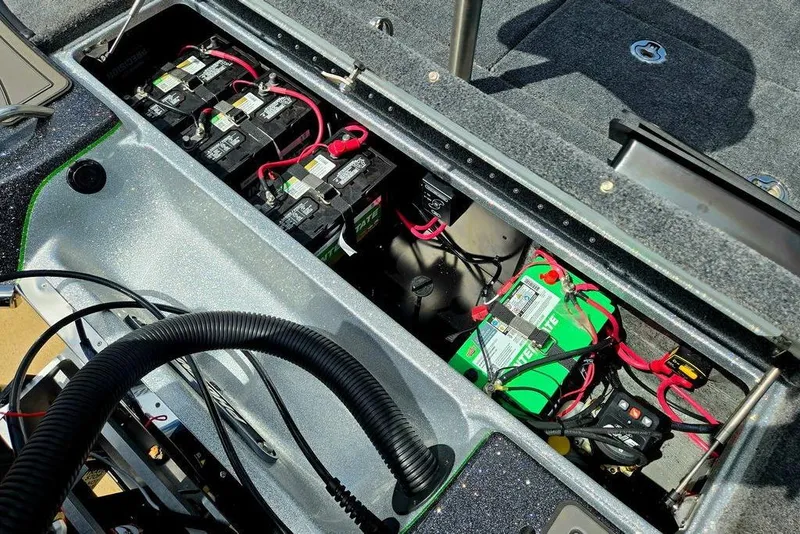 Slide: The Image of Battery compartment of a 2027 Phoenix 721 ZXL boat, showing multiple batteries and wiring. - 65