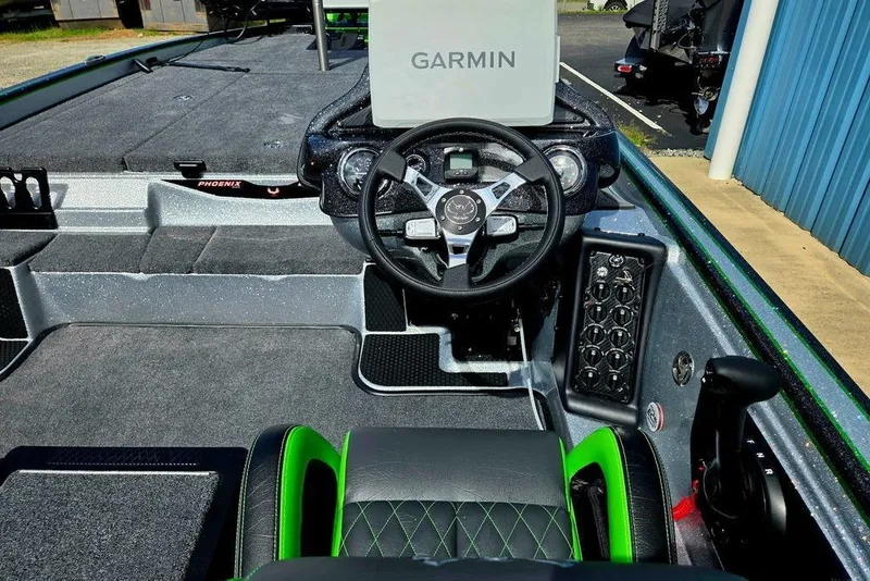 Slide: The Image of 2027 Phoenix 721 ZXL boat cockpit with Garmin navigation system and sleek steering wheel. - 74