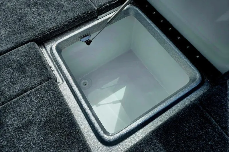 Slide: The Image of Open storage compartment in 2027 Phoenix 721 ZXL boat, featuring carpeted flooring. - 63